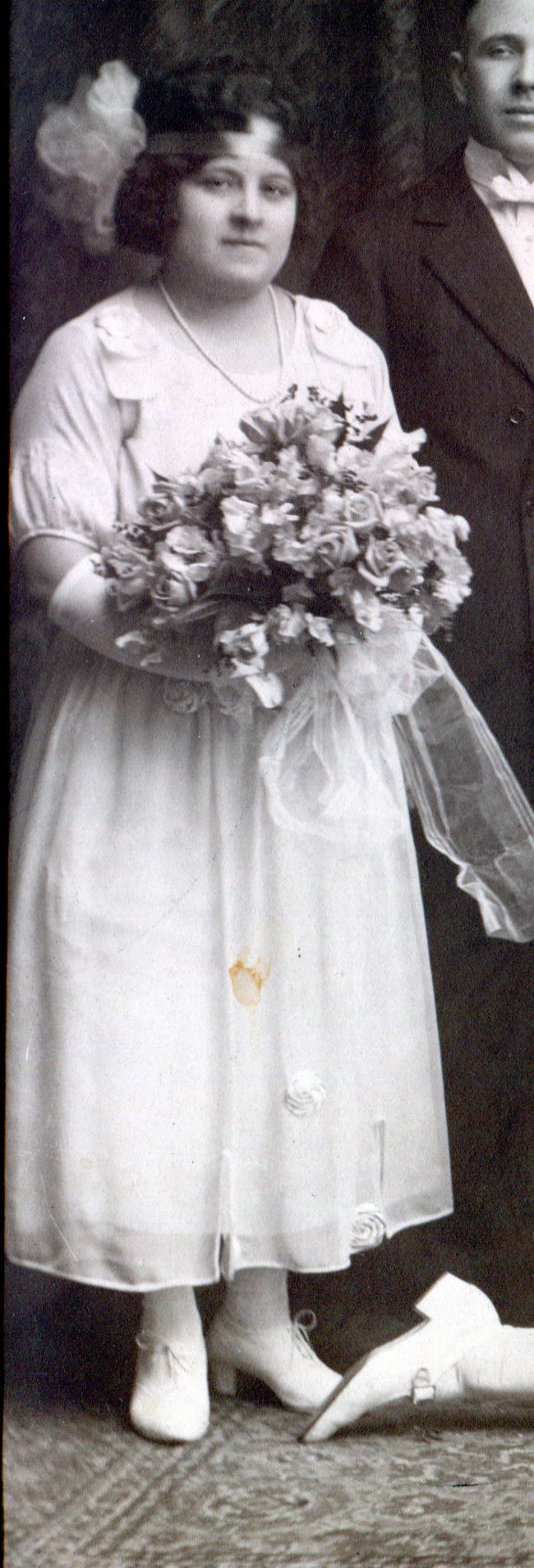 Bridesmaid with simple chiffon ankle-length dress and a large bouquet of flowers.