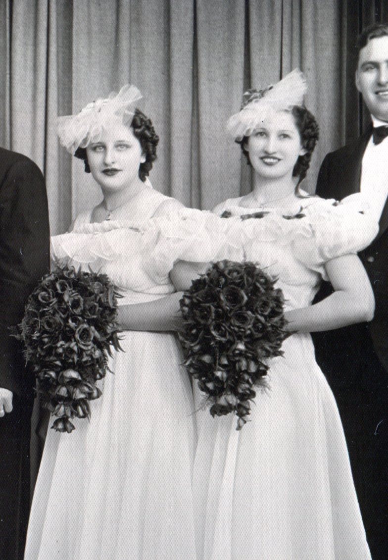 2 bridesmaids with bouquets and net headpieces