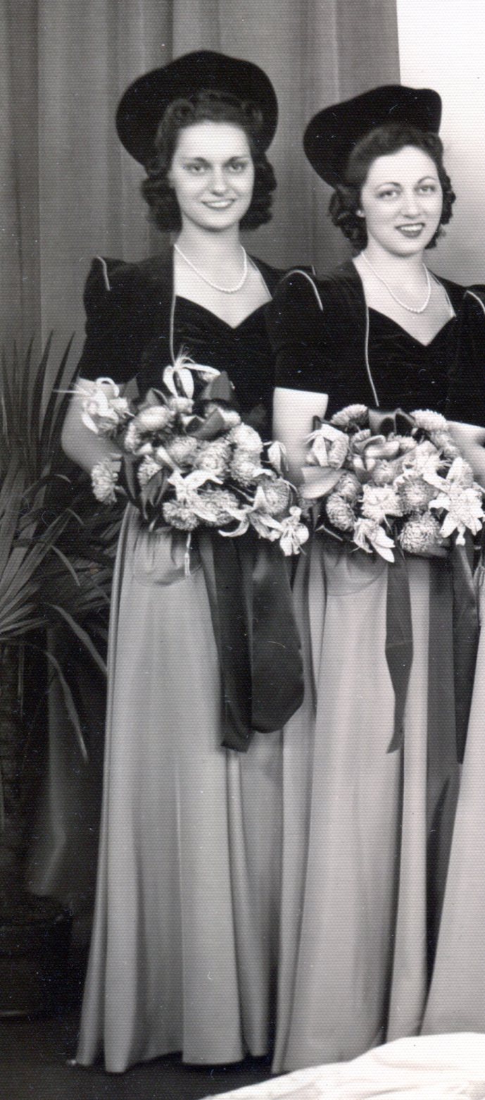 Bridesmaids' dresses of dark velvet tops with long slightly gathered taffeta skirts.