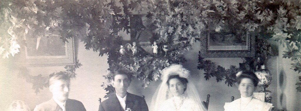 Wedding room decorated with branches of artificial leaves decorating the wall.