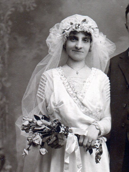 Bridal bodice showing two overlapped pieces edged in flat decorative band