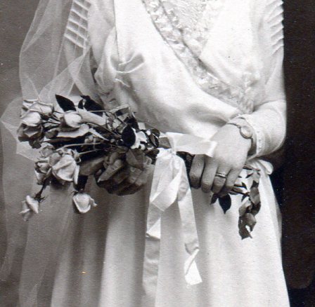 Bridal bouquet of long stem roses tied with white satin ribbon.