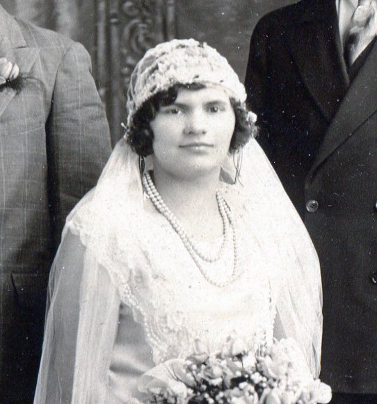 Close up of Bridal Cap made of veil net and appliques over a wire frame with veil attached at back