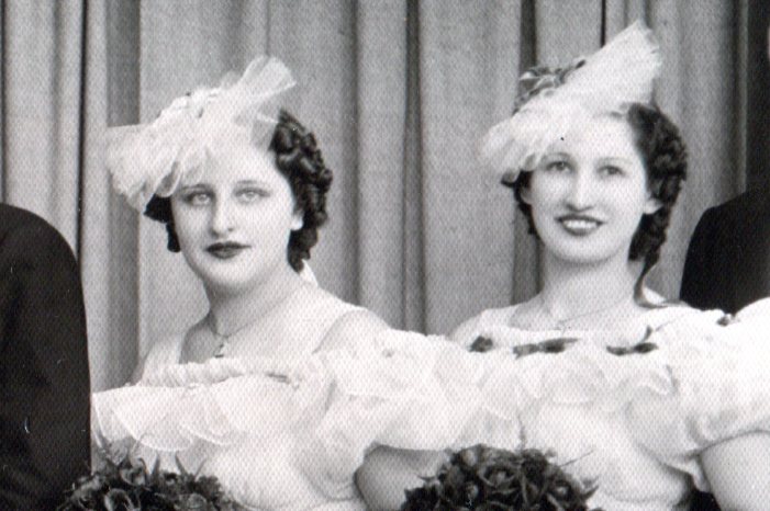 Close up of bridesmaids' headpieces made of gathered netting that creates a flat disk.