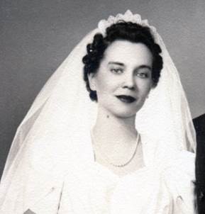 Close up showing bridal headpiece made of pearl strings on a starched mesh foundation to make a tiara.