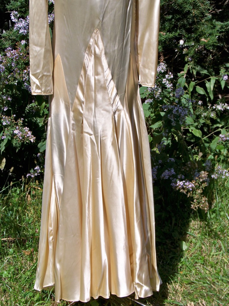 Triangular pieces called Godets sewed to the top of the dress make up the slightly flared skirt.