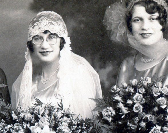 Bride wearing a bridal cap of lace that becomes her long veil