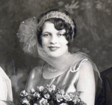 Bridesmaid wearing headband of gathered chiffon with a large net poof with sequins on the side of her head