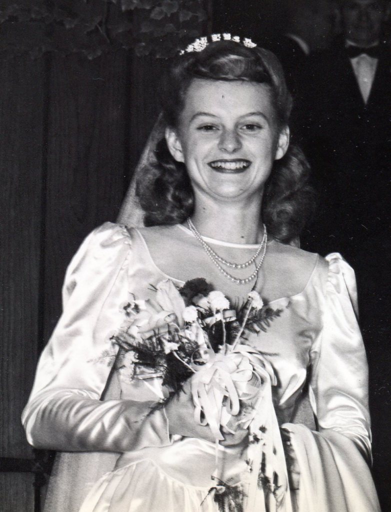 Close up of Bride showing open Sweet Heart neckline with sheer fabric filling it in. Long sleeves are puffed at the top.