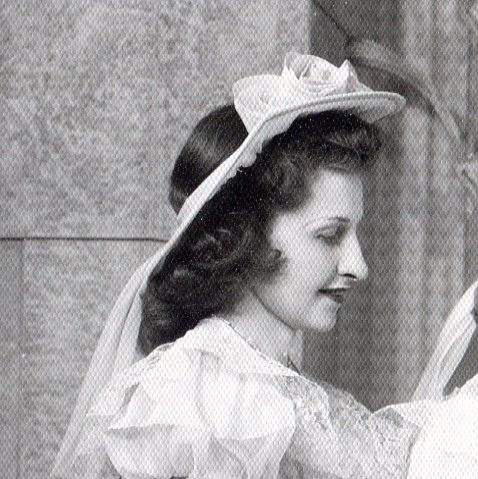 Close-up of Bridesmaid showing her headpiece which is a chiffon covered ring.