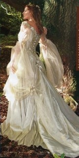 Woman in a long, white, flowing gown inspired by a Medieval dress style.
